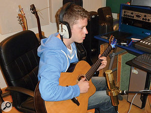 Tom McKenzie, tracking acoustic guitar for one of his tunes. Tom McKenzie, tracking acoustic guitar for one of his tunes.