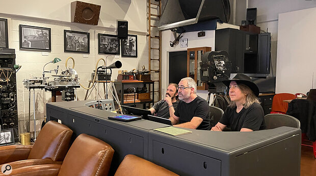 Left to right: editor Dan Gitlin, sound supervisor Nick Bergh and director Bernard MacMahon at Endpoint Audio Labs. The gravity‑fed lathe restored by Nick and featured in American Epic is visible against the wall to the left, along with part of its associated rack of power amplifiers.