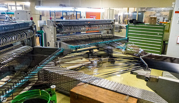 An 80cm‑wide roll of freshly made tape is cut into quarter‑inch strips at the RTM factory.