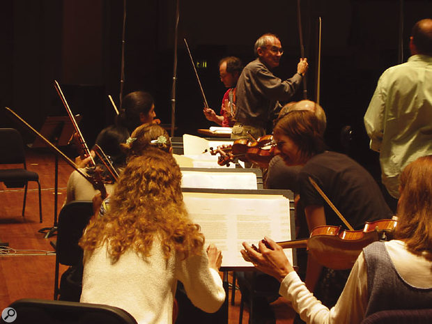 Placing the stage mics at the Symphonic Orchestra sessions. Professor Keith O Johnson (centre, grey shirt and glasses) can be seen fine-tuning the mic positions.