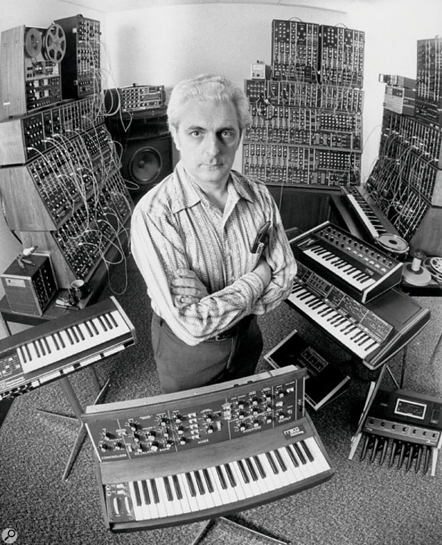 Bob Moog in the '70s with his by-then considerable range of non-patchable synths. Three complete modular systems are visible in the background.