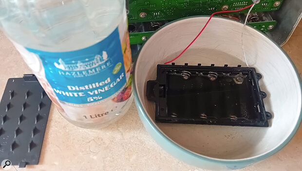 Removing the battery compartment and soaking it in distilled white vinegar removed most of the gunk that had leaked out of the batteries.