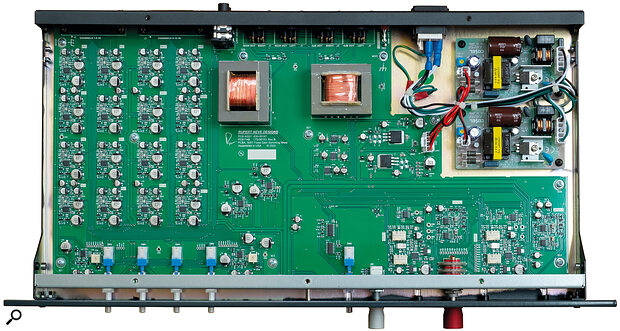 The circuitry is carried on a single large PCB with a separate OEM module for the power supply. Four columns of input buffers occupy the top left of the board, with the two orthogonal output transformers alongside. The mix‑bus amps are either side of the mono buttons, with the Silk circuitry and output sections at the right front.