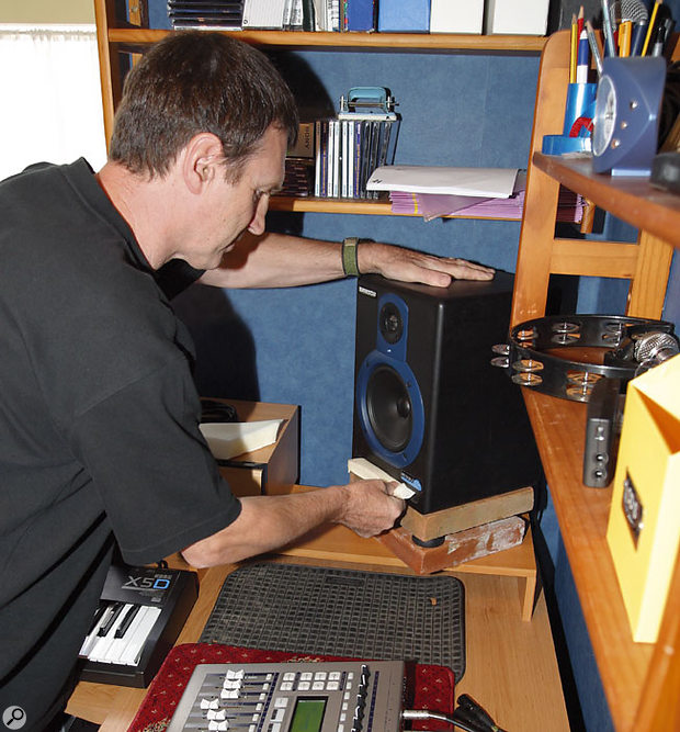 In order to treat a marked room resonance at 110Hz, each speaker was first isolated from the desk, which was exacerbating the problem, using two heavy quarry tiles separated by the speakers' rubber feet. A further improvement was made by inserting a small piece of acoustic foam into each speaker's reflex port, raising the low-frequency roll-off point.