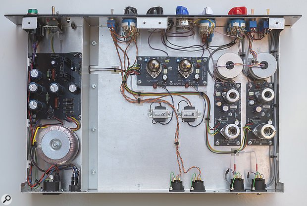 A very neat build, with lots of handwiring between four circuit boards. The gain stages built around a pair of pentodes for each preamp are on separate boards, positioned alongside the chunky 'canned' Sowter input transformers. The output drivers of both channels share a third circuit board, with the diminutive line output transformers below. A linear power supply is accommodated on the fourth board, located behind a metal screen.