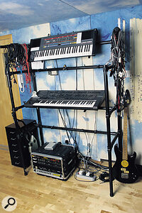 Keyboards and digital recording: Roland Juno 106S & JD800. The floor pod contains the Opcode Studio 4 MIDI interface, Digidesign Pro Tools hardware, I/O units, and SMPTE Slave Driver, plus a Tech 21 Sansamp speaker simulator. A Vox Bass can also be seen on the right.