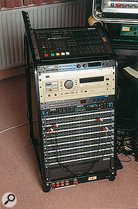 The outboard rack: from top, BRC remote controller for ADATs, Lexicon PCM91 reverb, SoundLink converter box for Korg 1212 I/O card, Panasonic DAT recorder, Alesis Midiverb III effects, MOTU MIDI Timepiece. Behind the rack (top left) are the Joemeek Voice Channel and Yamaha TX7 synth module.