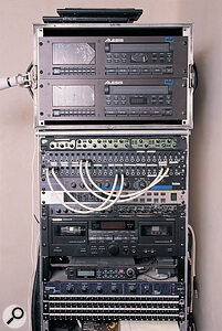 The Serious Hat Band's gear resides in two racks, one of which stays in the studio while the other travels as part of their PA rig. This is the studio rack: from top, Alesis ADAT multitrack recorders, Focusrite Green channel strip, patchbays, Lexicon MPX100 multi‑effects, Behringer Virtualizer Pro multi‑effects, Alesis 3630 compressor, Tascam dual cassette deck, Casio DAT, SPL Vitalizer Jack enhancer, and more patchbays.