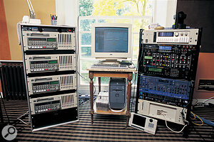 The equipment in the digital suite includes four Tascam DA98 digital 8‑track recorders (left), and an Apple G4 computer (centre). The rack to the right contains, from top, an Akai S3200XL sampler, Roland VP9000 Variphrase processor, Studio Electronics ATC1 'Minimoog in a rack', Roland JV2080 sound module, Novation Supernova synth, Emagic Unitor 8 MIDI interface, MOTU 2408 audio interface and Digital Timepiece synchroniser, and Akai S6000 sampler.