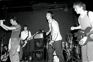 Mitch Easter joins REM on‑stage at the 9:30 Club, 1982. From left to right: Michael Stipe, Mike Mills, Peter Buck, Bill Berry and Mitch Easter.