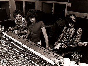 Jack Douglas and Jay Messina recording a Joe Perry guitar part while Steven Tyler does the crossword.