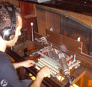 The ‘TypoSonic Machine’, an instrument constructed by modifying a  manual typewriter, where the key-strikes hit bass guitar strings. When it is acoustically coupled to the upright piano, the piano strings create sympathetic vibrations and amplify the sound. 