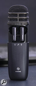 The wireless earbuds can be stored and charged inside the mic itself, by sliding the outer shell of the mic down.