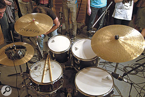 In addition to a  main Neumann TLM103 overhead pair (not shown), the drum kit had close mics on every drum: an SM57 on the snare; Neumann TLM102 condensers on the toms; an AKG D112 on the kick; and another TLM103 positioned alongside the snare.