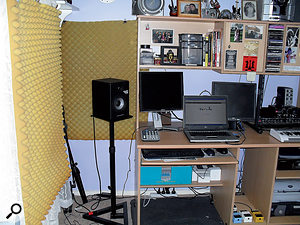 Joe bought some speaker stands to elevate his Alesis monitors to the correct level, and hung some spare furniture foam on the walls to tame the early reflections.