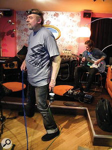 Dallas Simpson's movements during the show are choreographed to bring him into proximity with different 'layers' in the band's sound. In the background here is bassist Blake Pearson. As well as the binaural microphones tucked almost invisibly into his ears, Dallas also wears a head-mounted video camera, which is projected to the audience.