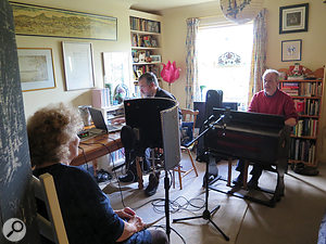 Shirley and Ian with portable harmonium — before it was covered with blankets.