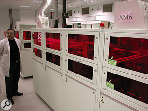 The CD manufacturing process begins with a laser machine that cuts glass master discs. 