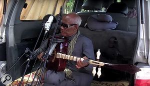 The back of a van made a handy wind-proof space to record Khmer Rouge survivor Kong Nai’s performance.