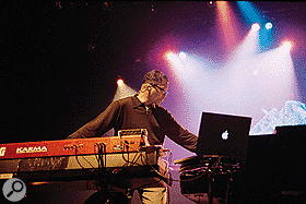 Herbie Hancock playing live on the Future2Future tour, with his Apple Powerbook (right), Korg Karma and Roland MK80 keyboards (left).