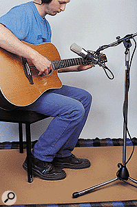 A piece of hardboard placed below an instrument while recording can make it seem closer and brighter.