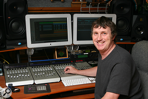 Paul White with two Apple monitors and Mackie controllers.