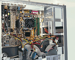 Inside view of an open PC case, showing circuitry, drives and power supply.