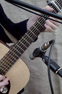 If you have only one mic on the guitar, the neck/body joint is often a good starting point (left); if you want to add a second mic, or are in search of a thicker sound, a position somewhere behind the bridge often works well.