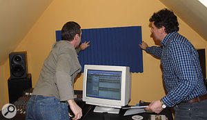 Temporarily placing a panel of acoustic foam behind the monitors facing the monitoring position confirmed that this would improve the sound by avoiding strong reflections from the wall.