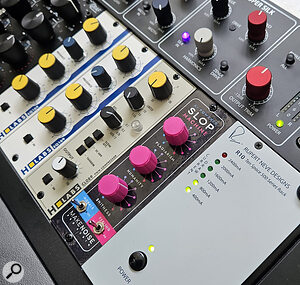 AI-powered Slop Machine (pink knobs) from Make Noise Pro Audio and H Labs CL089 PWM Compressor to its left.