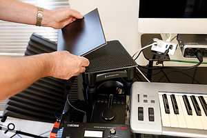 A pair of IsoAcoustics monitor stands were used to decouple the monitors from the desk. Ceramic tiles were placed on top of the stands to add mass, as the stands were designed for larger monitors than the Yamahas that Alex was using.