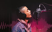 Why I Love... Imperfections photo of vocalist singing into studio mic.
